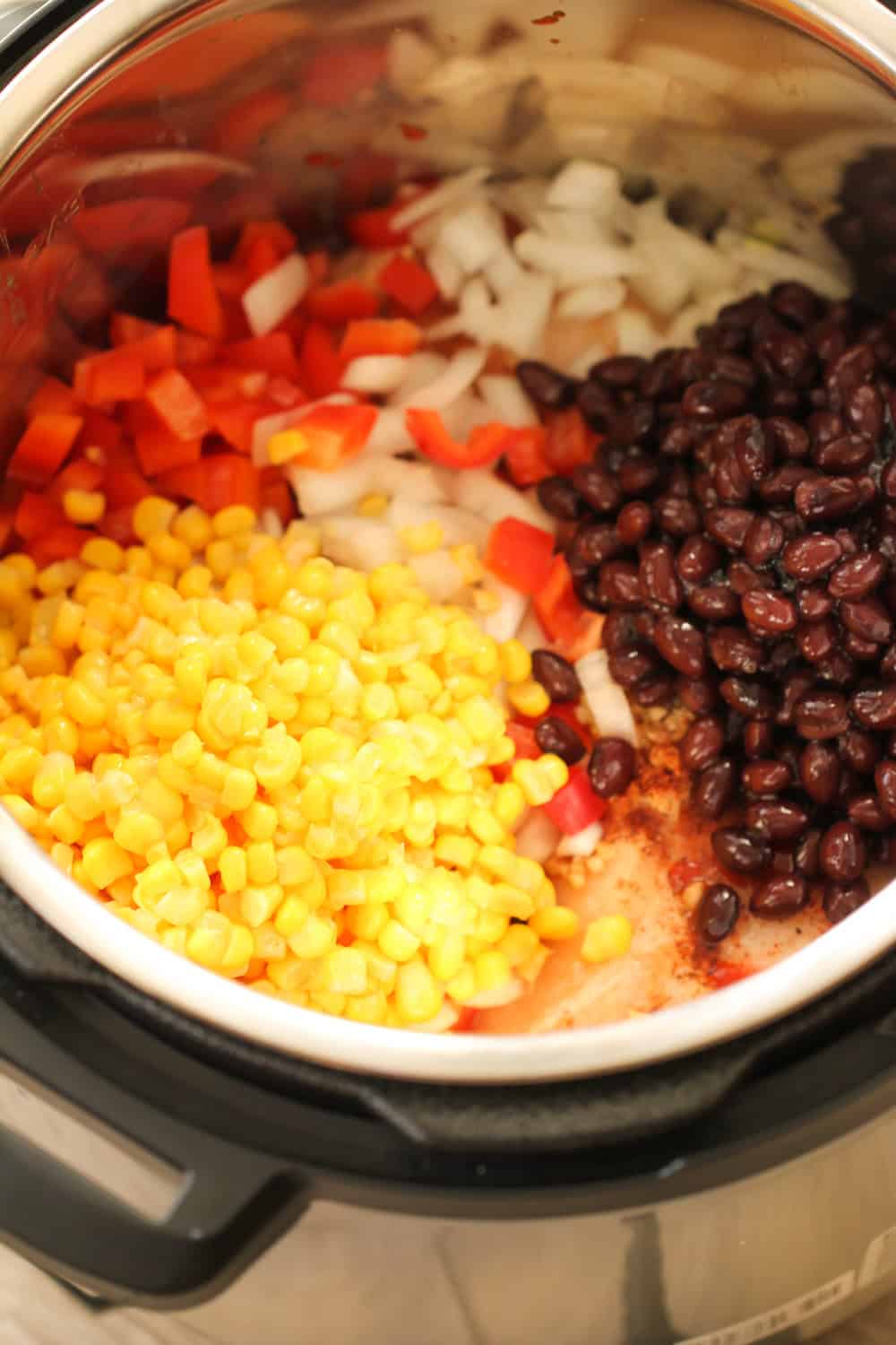 Veggies on top of chicken in the Instant Pot