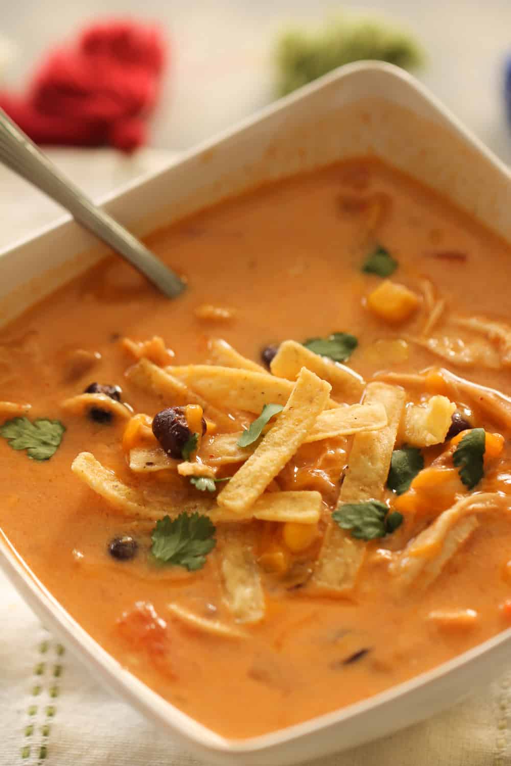 A bowl of Instant Pot Creamy Chicken Enchilada Soup topped with tortilla strips