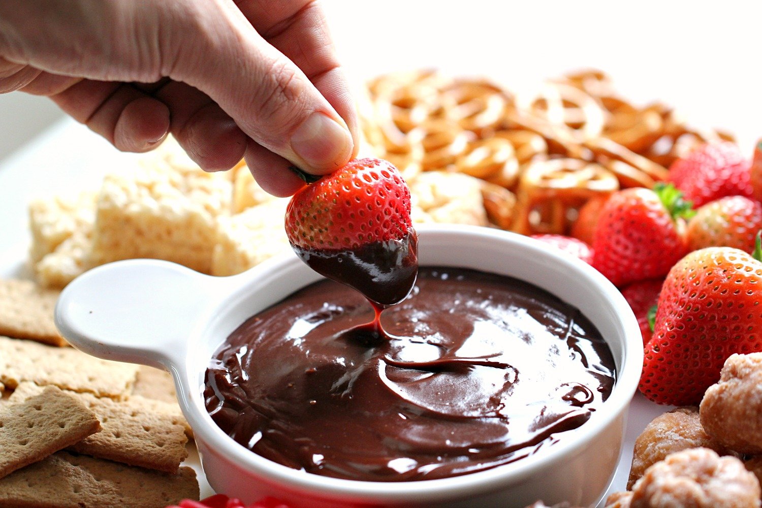 Dipping a strawberry in Instant Pot Melted Fondue