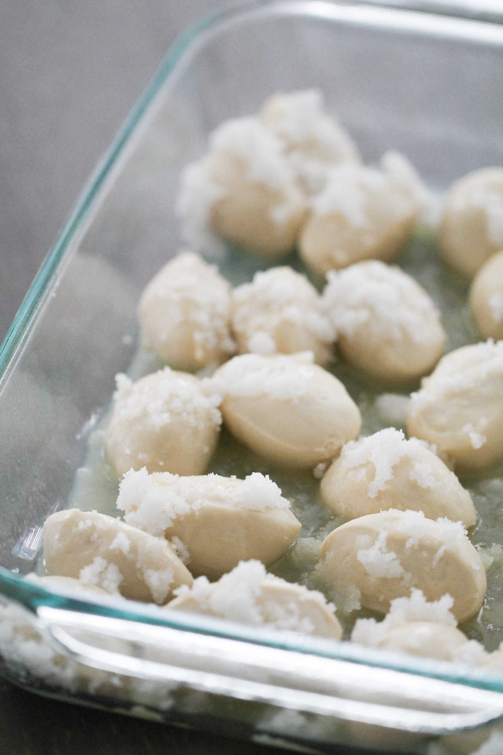 Close up of unbaked Easy Lemon Monkey Bread in a baking dish