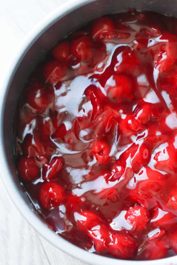 Cherry pie filling in a springform pan.
