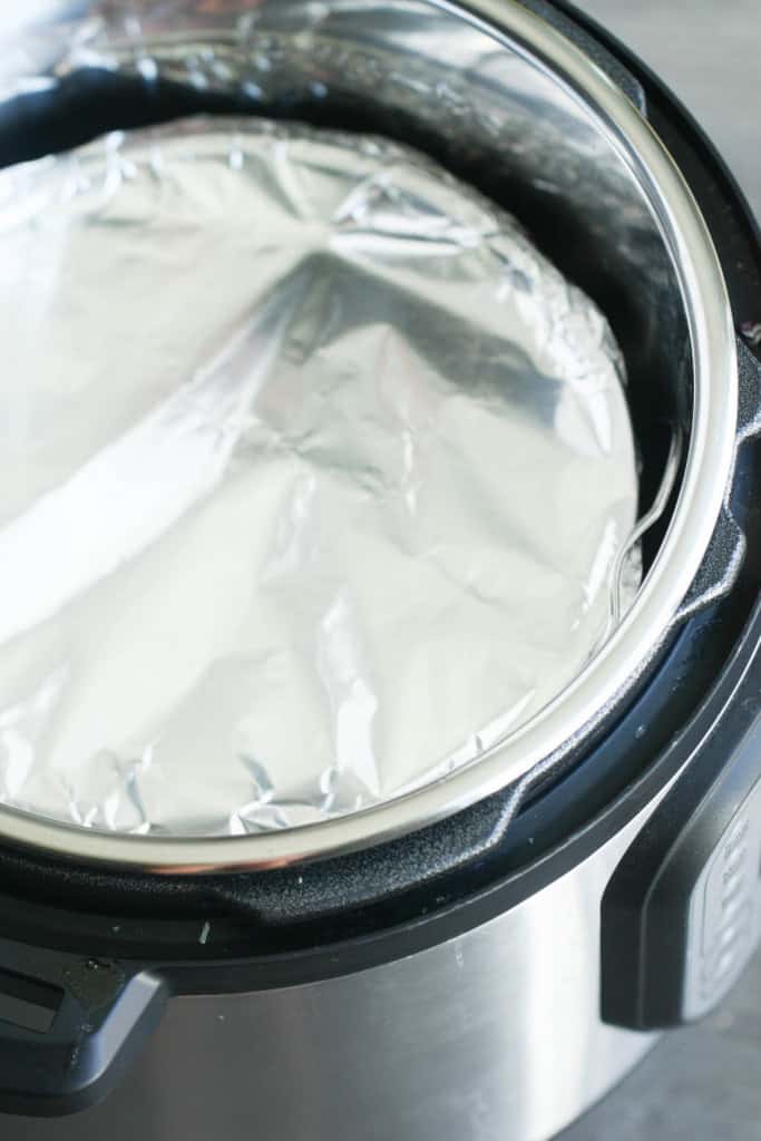 Spring form pan wrapped with foil and placed in Instant Pot.