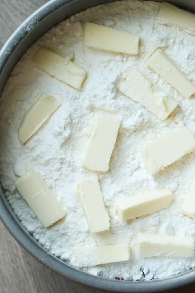 Small pieces of butter placed on top cake mix in spring form pan.
