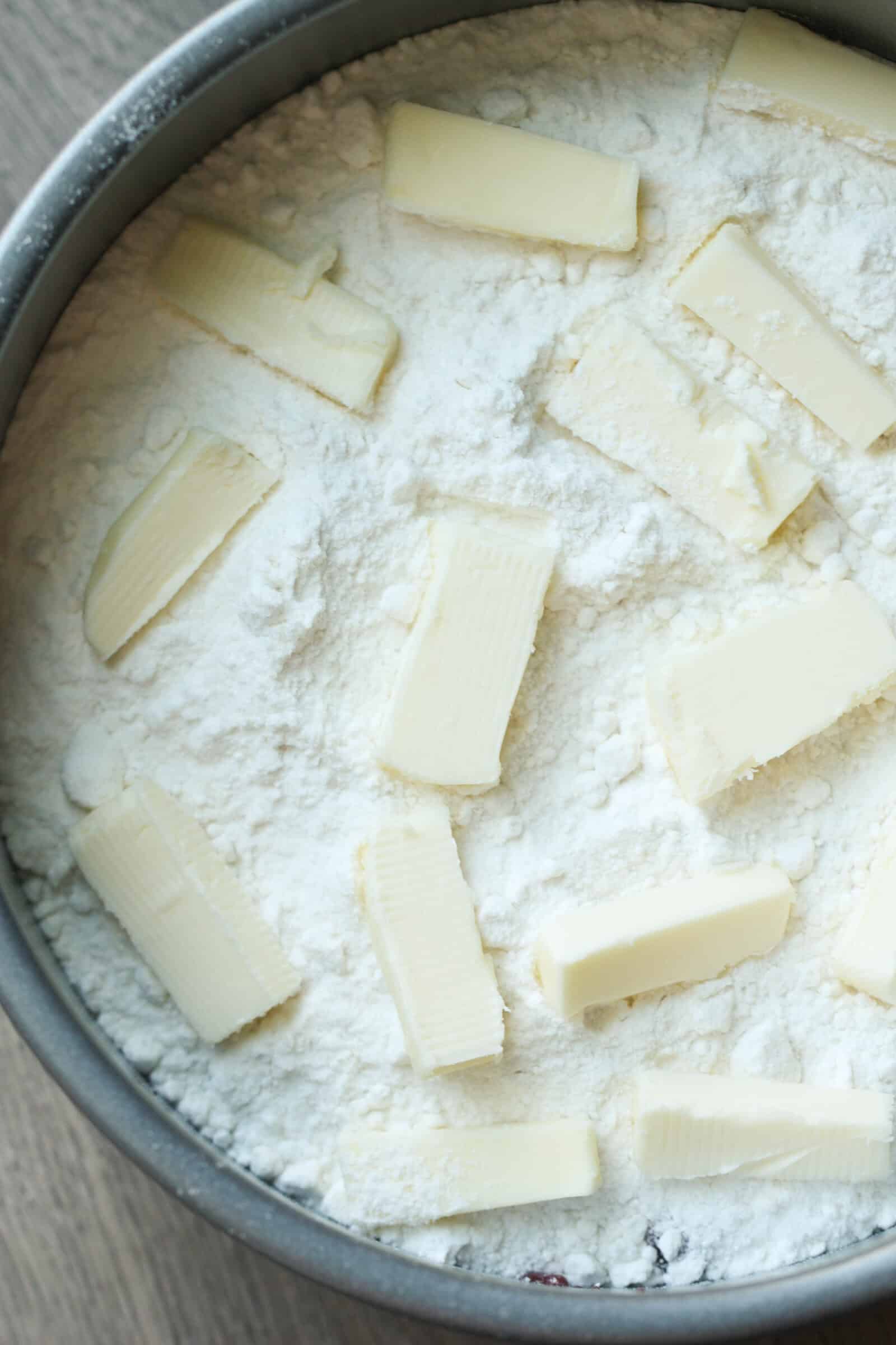 Butter pads on top of sprinkled cake mix