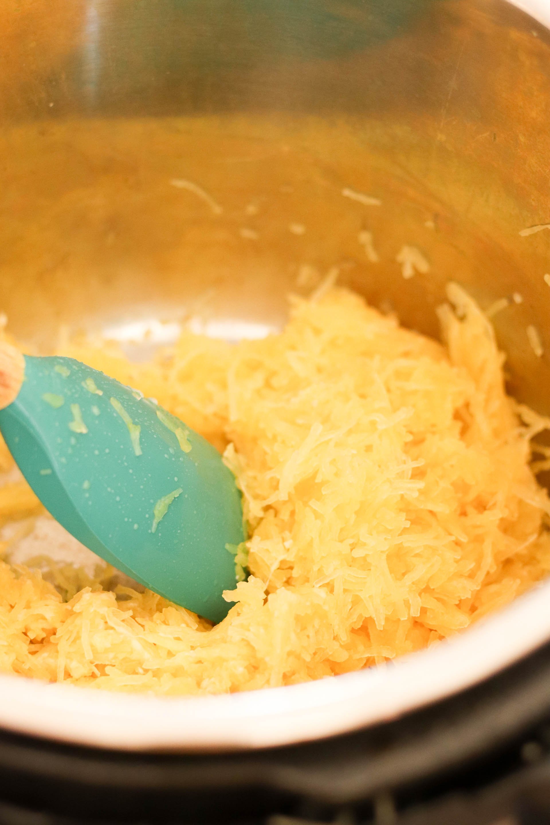 Shredded Spaghetti Squash in the Instant Pot with a rubber spatula