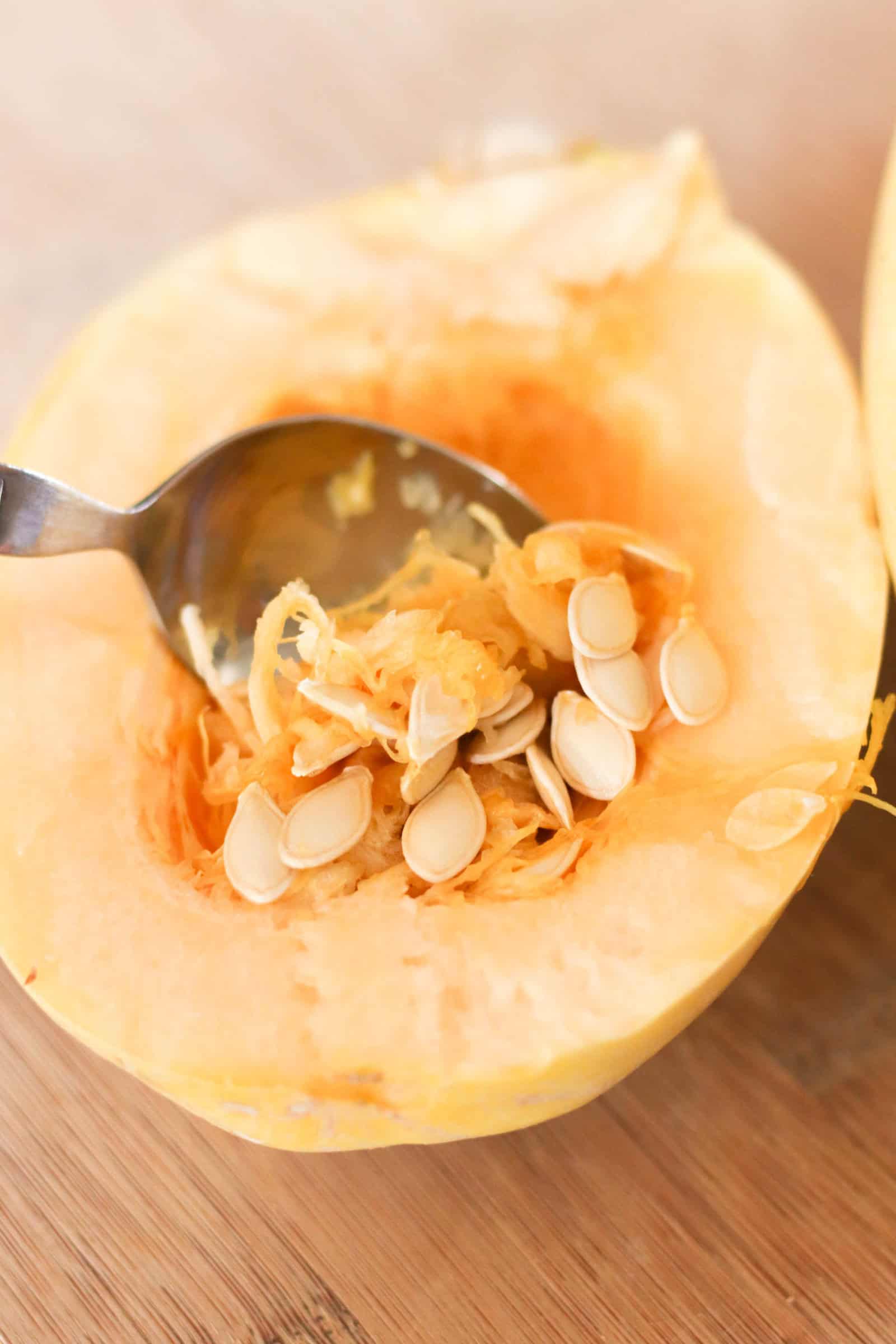 Scooping out spaghetti squash seeds