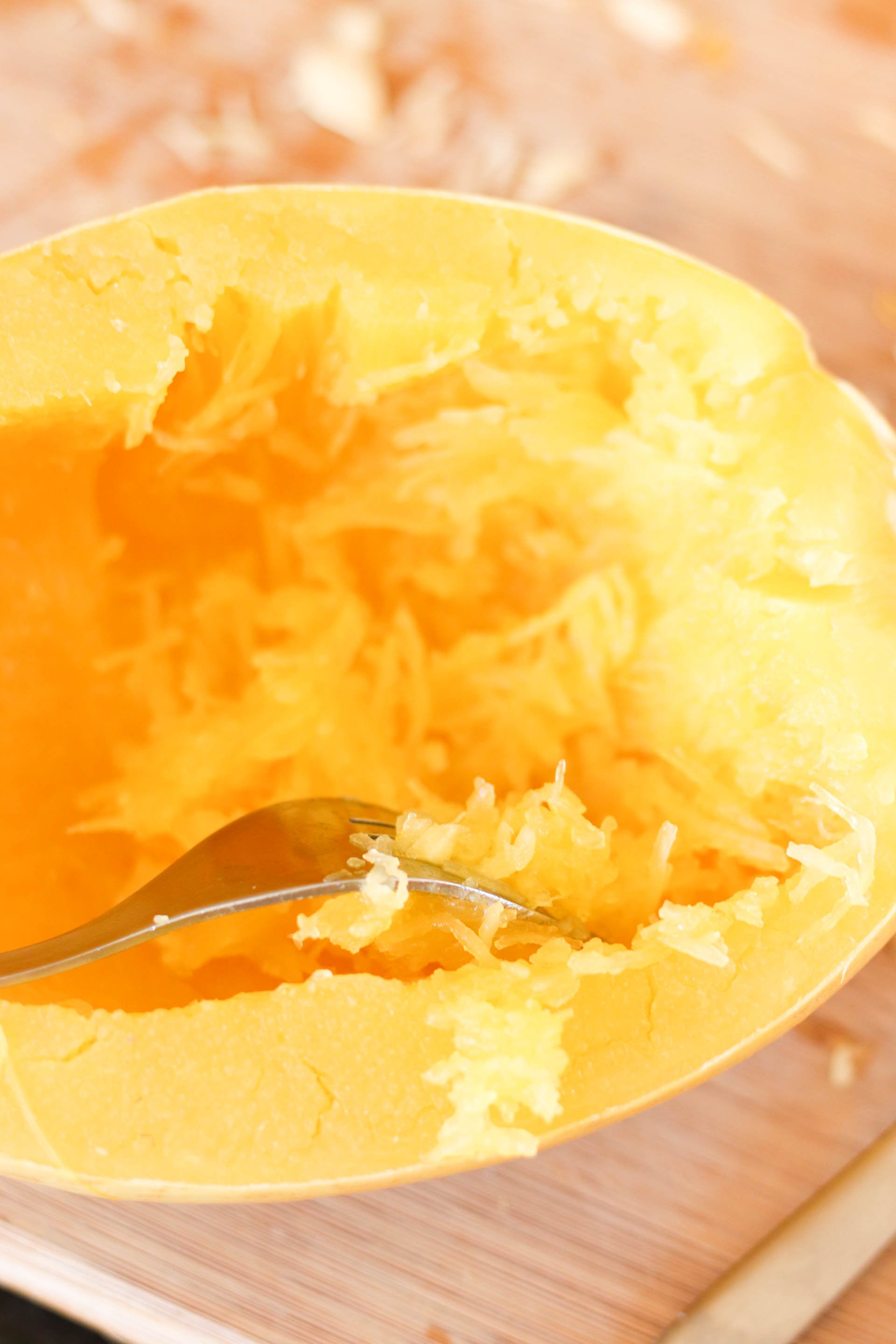 Using a fork to shred cooked spaghetti squash