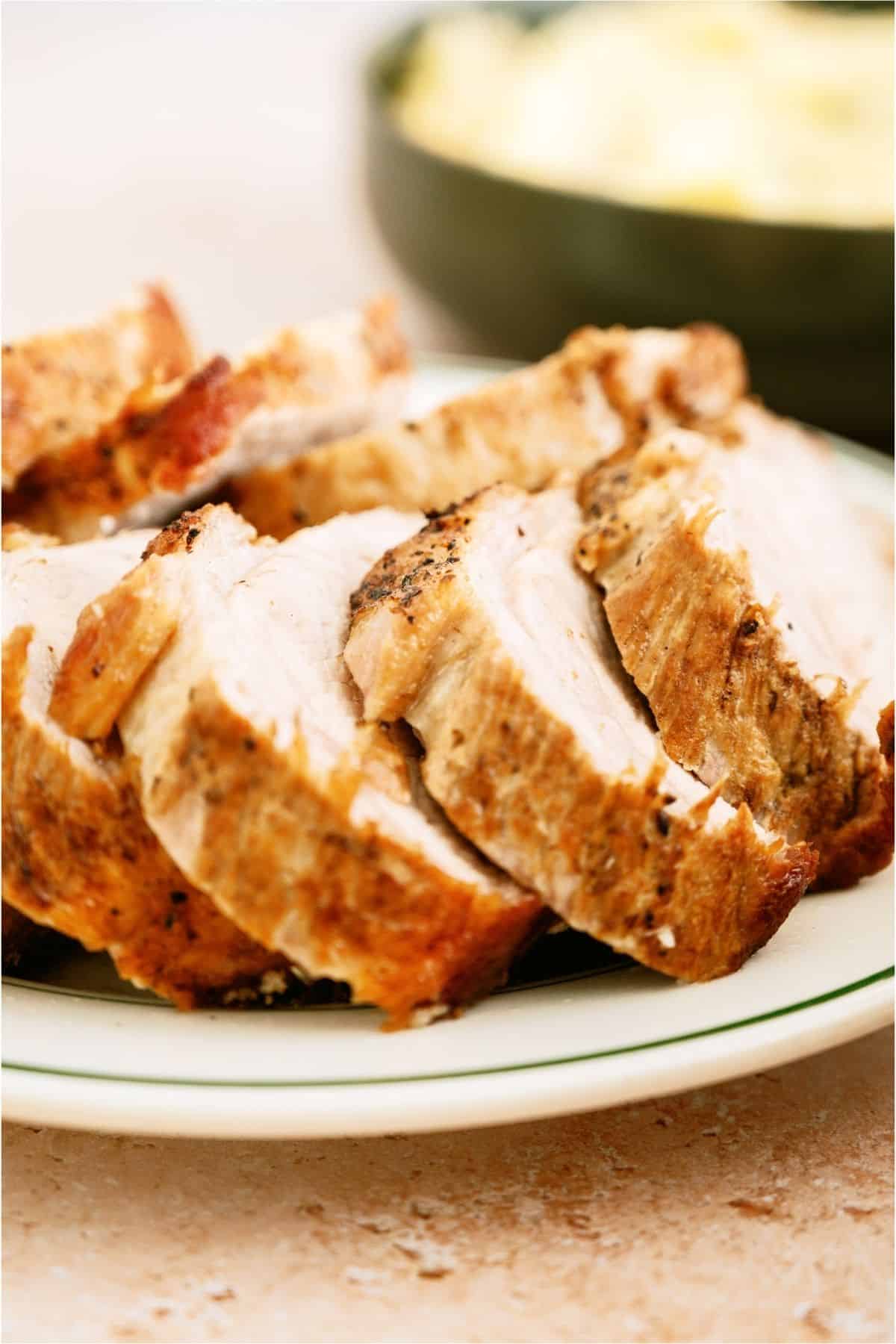 A plate filled with sliced Slow Cooker Company Pork Roast.