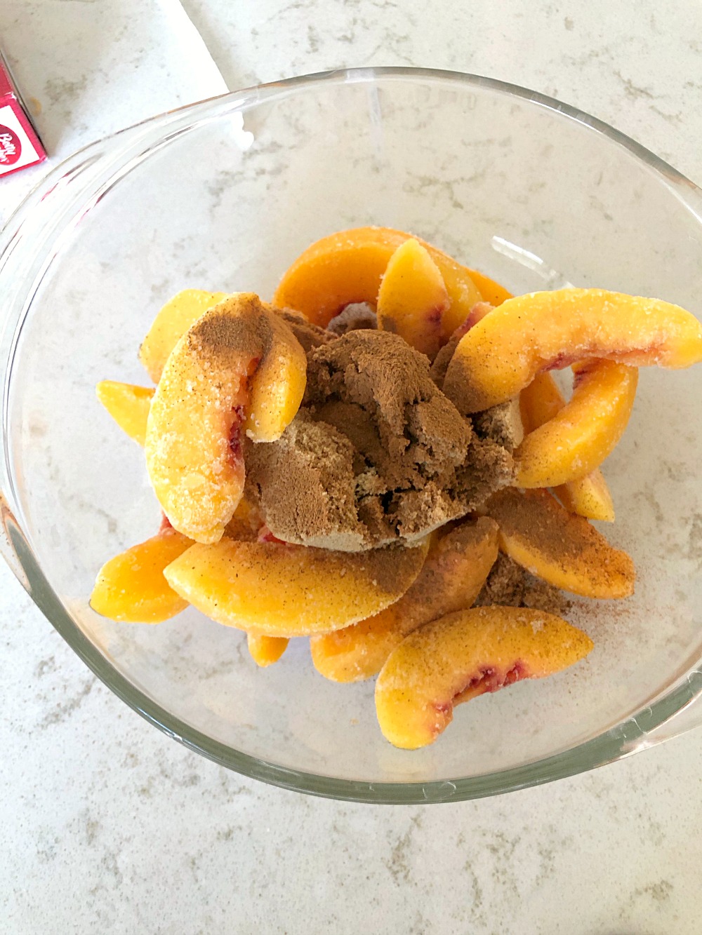 peaches and brown sugar in a glass bowl