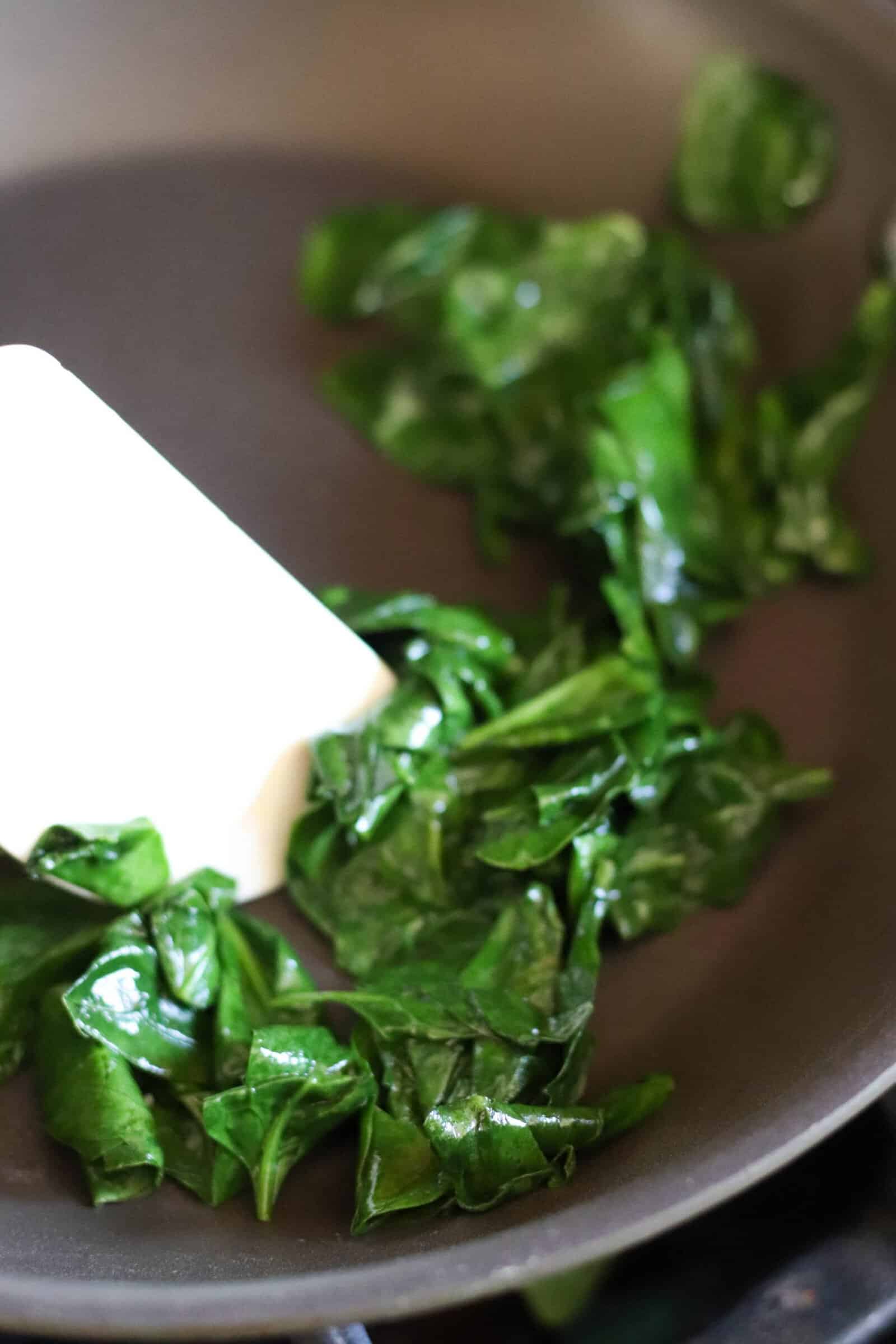 spinach wilted in a skillet over medium heat