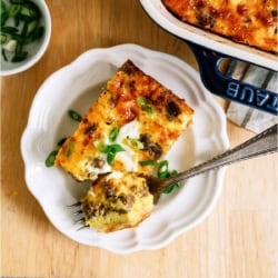 serving of Sausage Breakfast Casserole on a white plate with a fork.