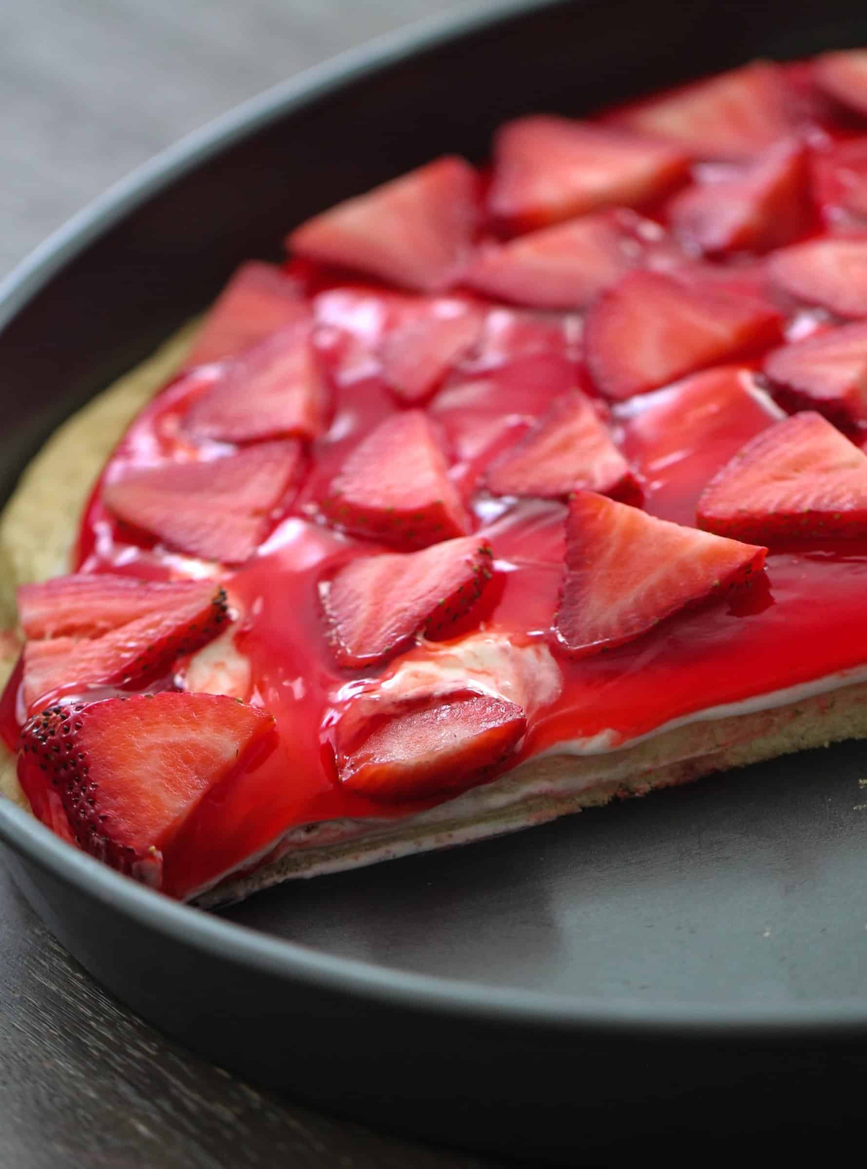 Strawberry fruit pizza with slice missing