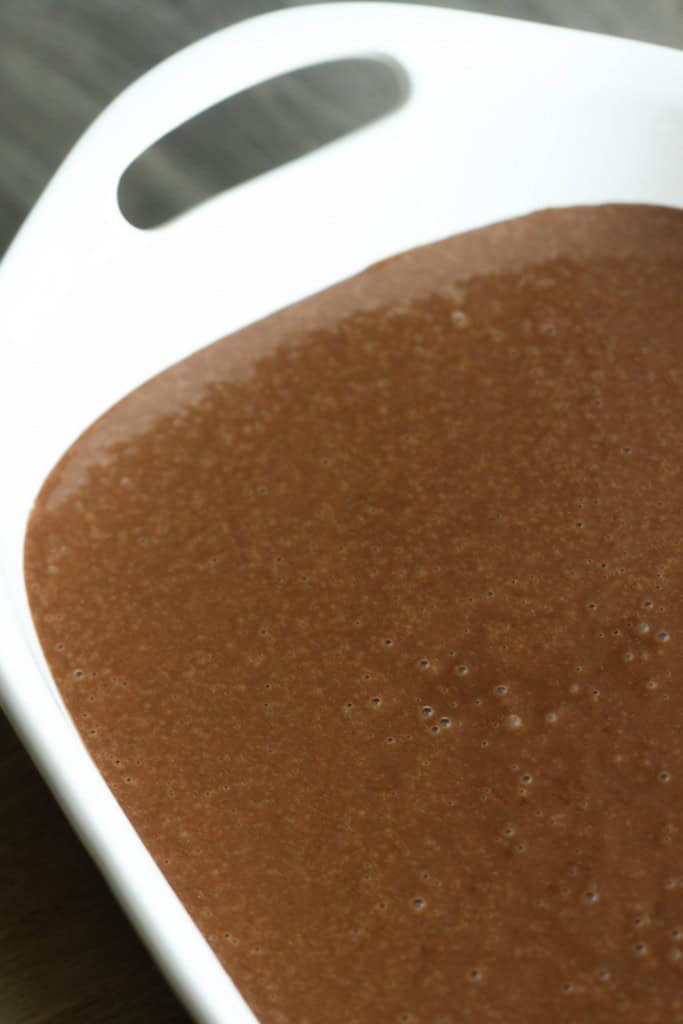 One Bowl Chocolate Cake batter poured into a 9x13 baking dish.