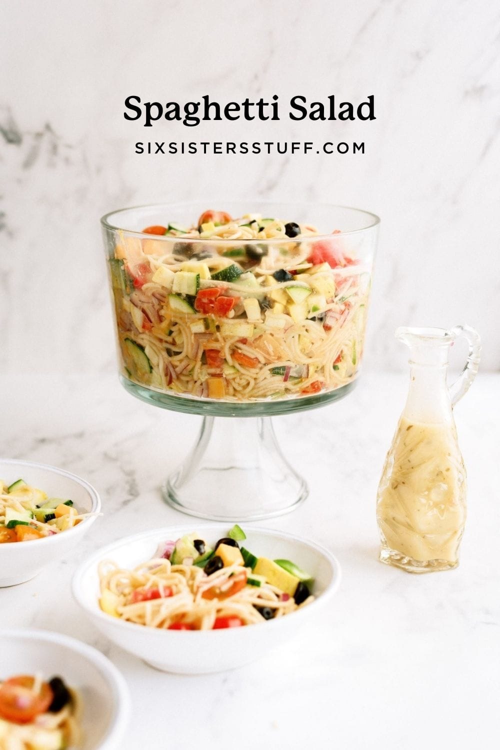 spaghetti salad in glass bowl with homemade dressing