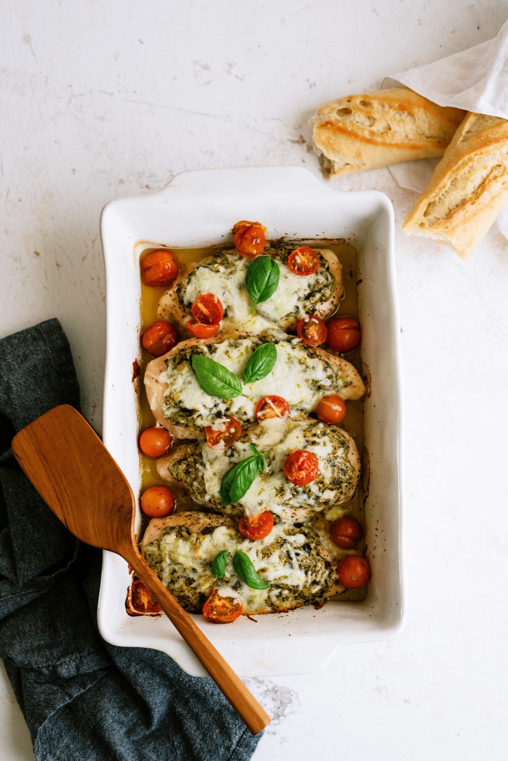 Pan of Easy Pesto Chicken Bake with bread on the side