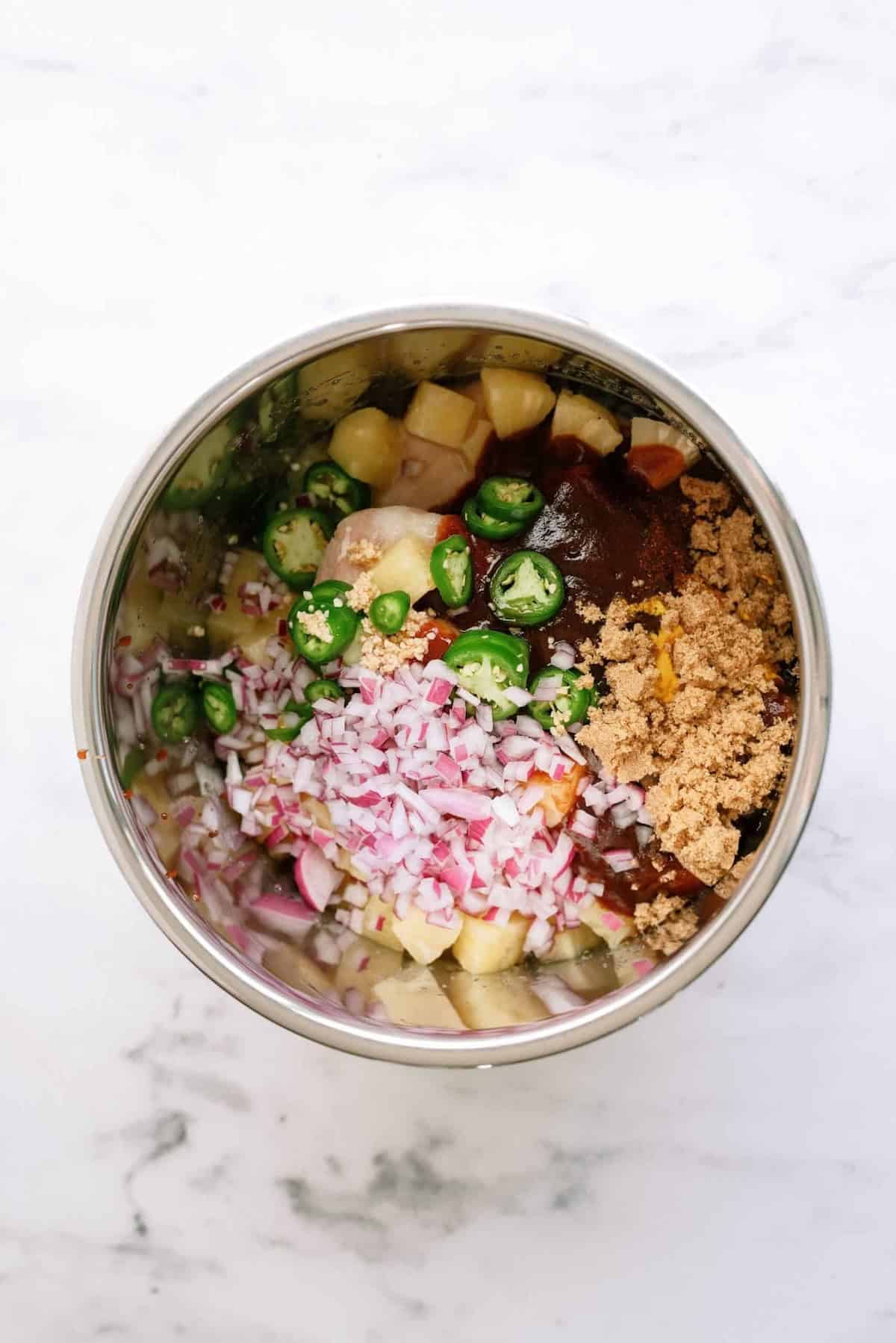 all the hawaiian bbq chicken taco ingredients in the inner pot of the instant pot