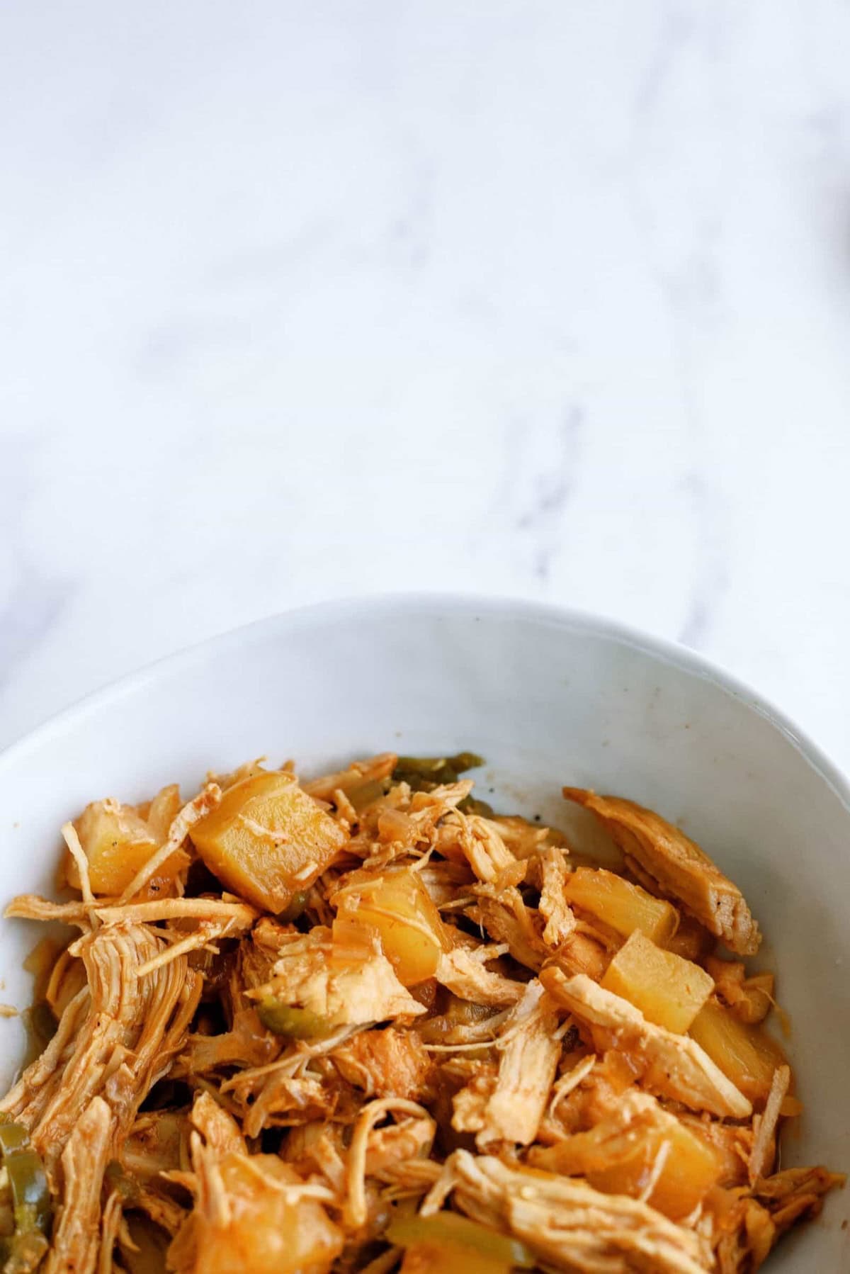 the cooked mixture of chicken, pineapple, onions and spices