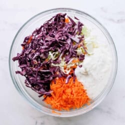 bbq chicken taco coleslaw ingredients in a bowl before mixing