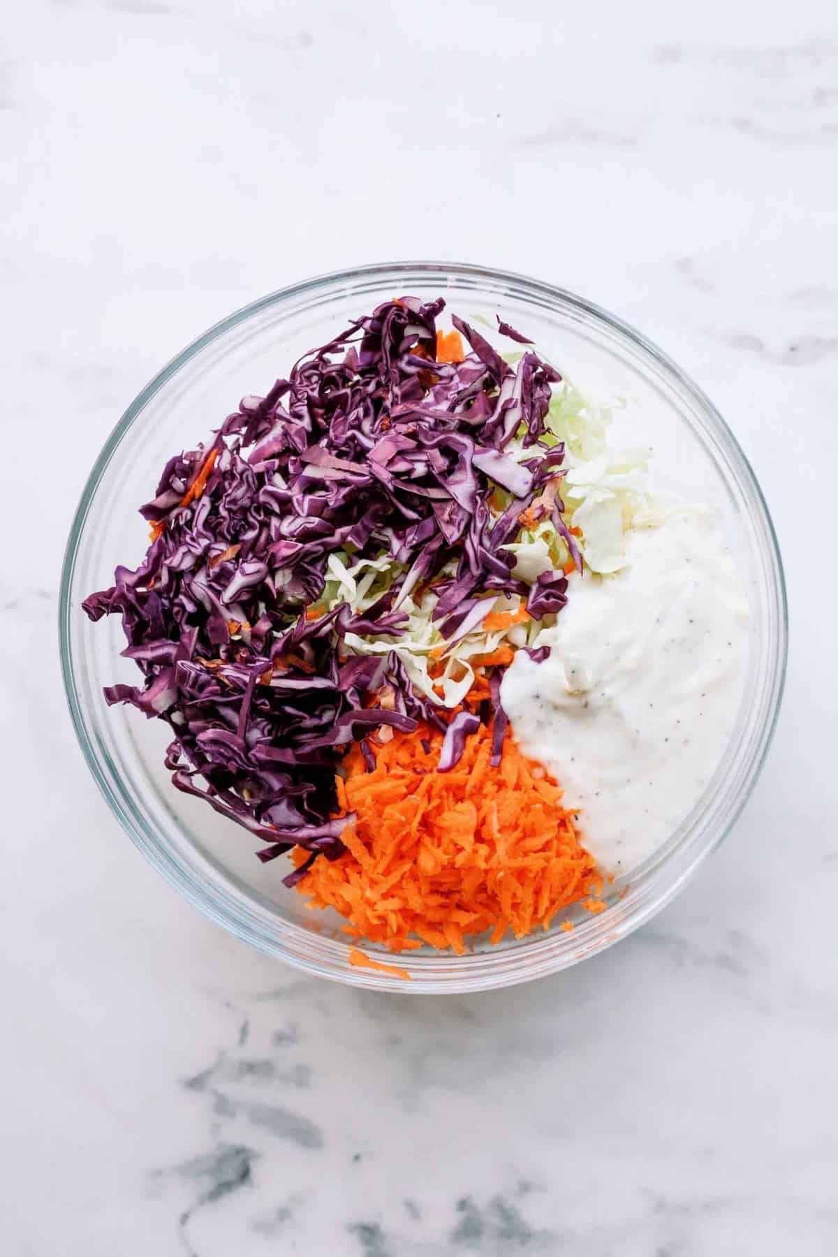 bbq chicken taco coleslaw ingredients in a bowl before mixing