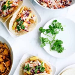 bbq chicken tacos in the instant pot with coleslaw and topped with cilantro