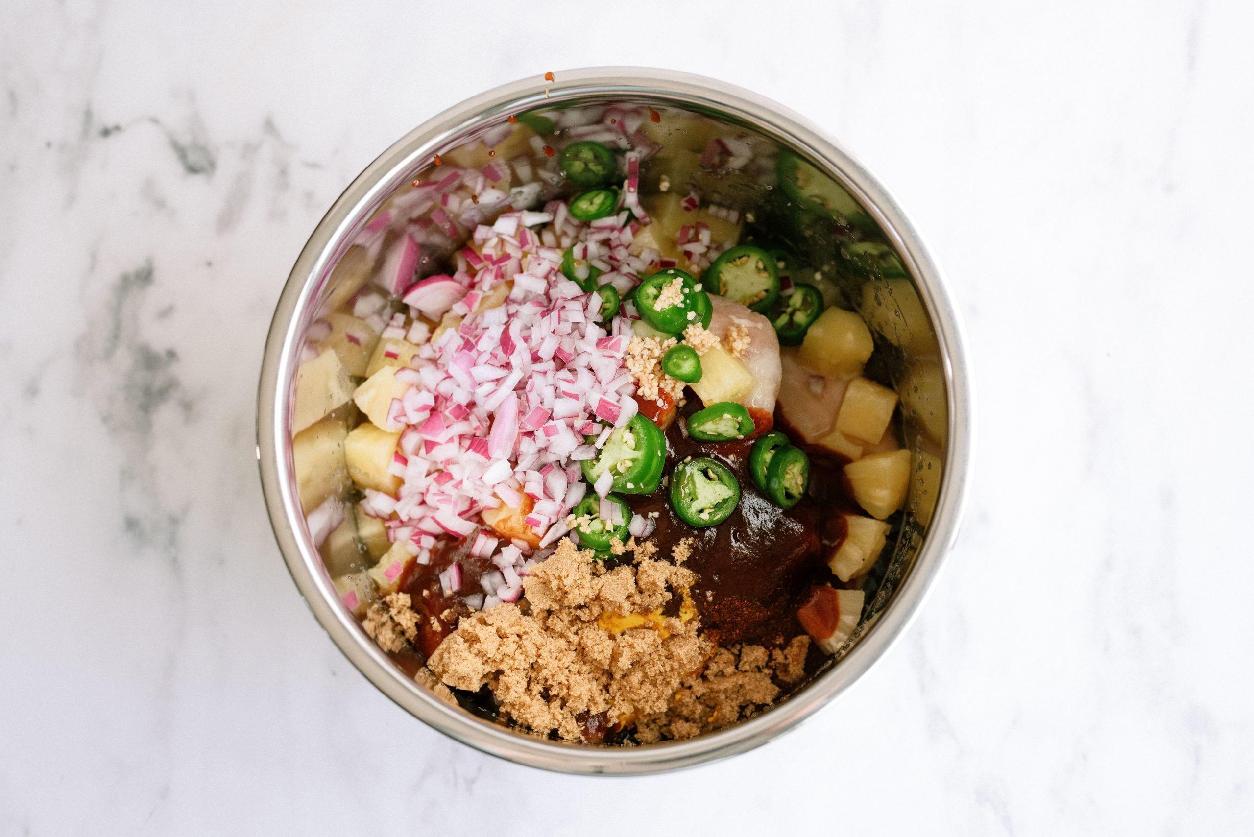 all the hawaiian bbq chicken taco ingredients in the inner pot of the instant pot