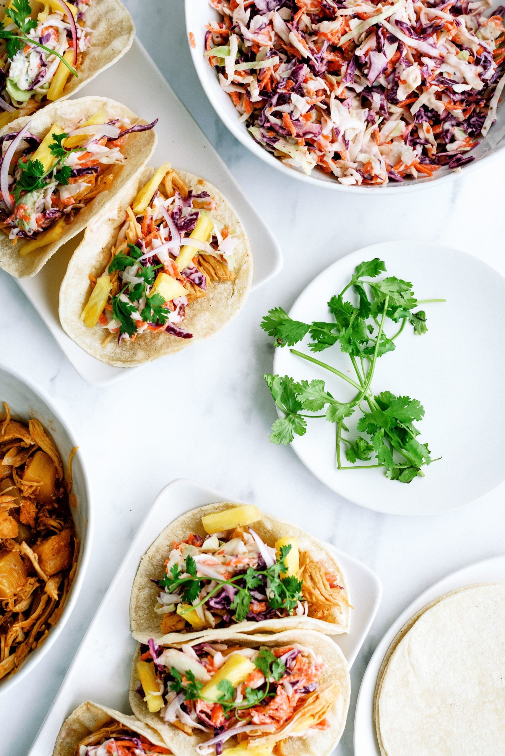 bbq chicken tacos in the instant pot with coleslaw and topped with cilantro