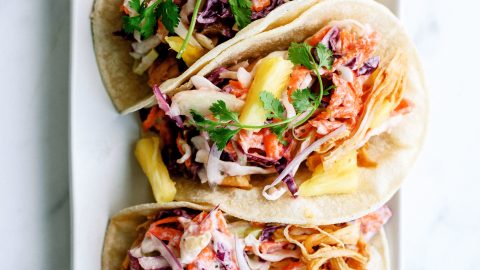 plated hawaiian bbq chicken tacos ready to serve with toppings of pineapple, cilantro, and onions