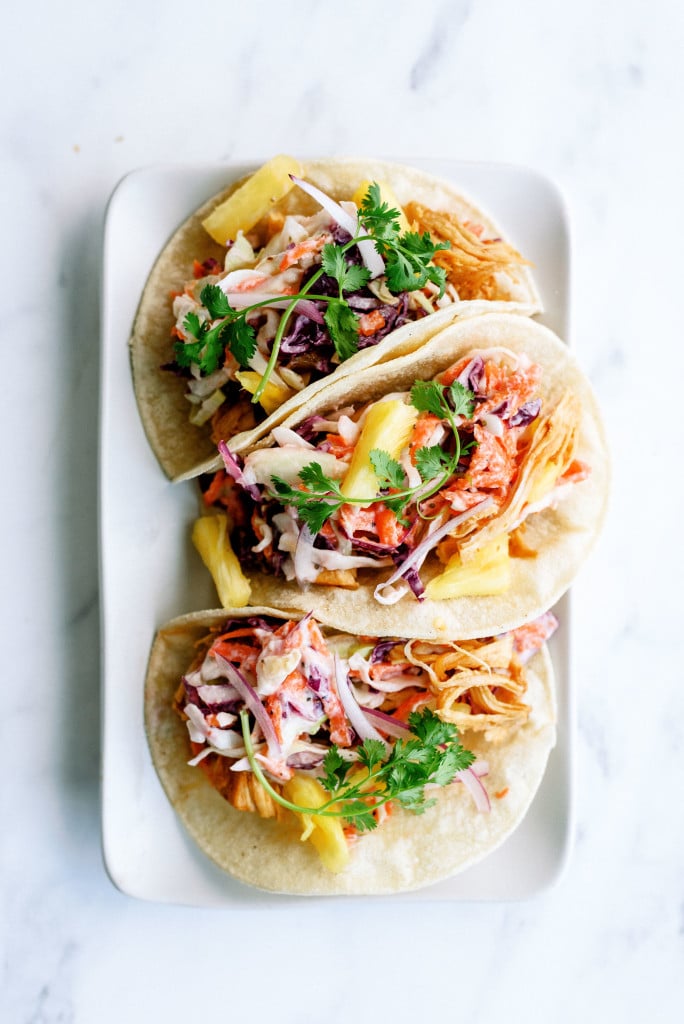 plated hawaiian bbq chicken tacos ready to serve with toppings of pineapple, cilantro, and onions that can be a freezer meal