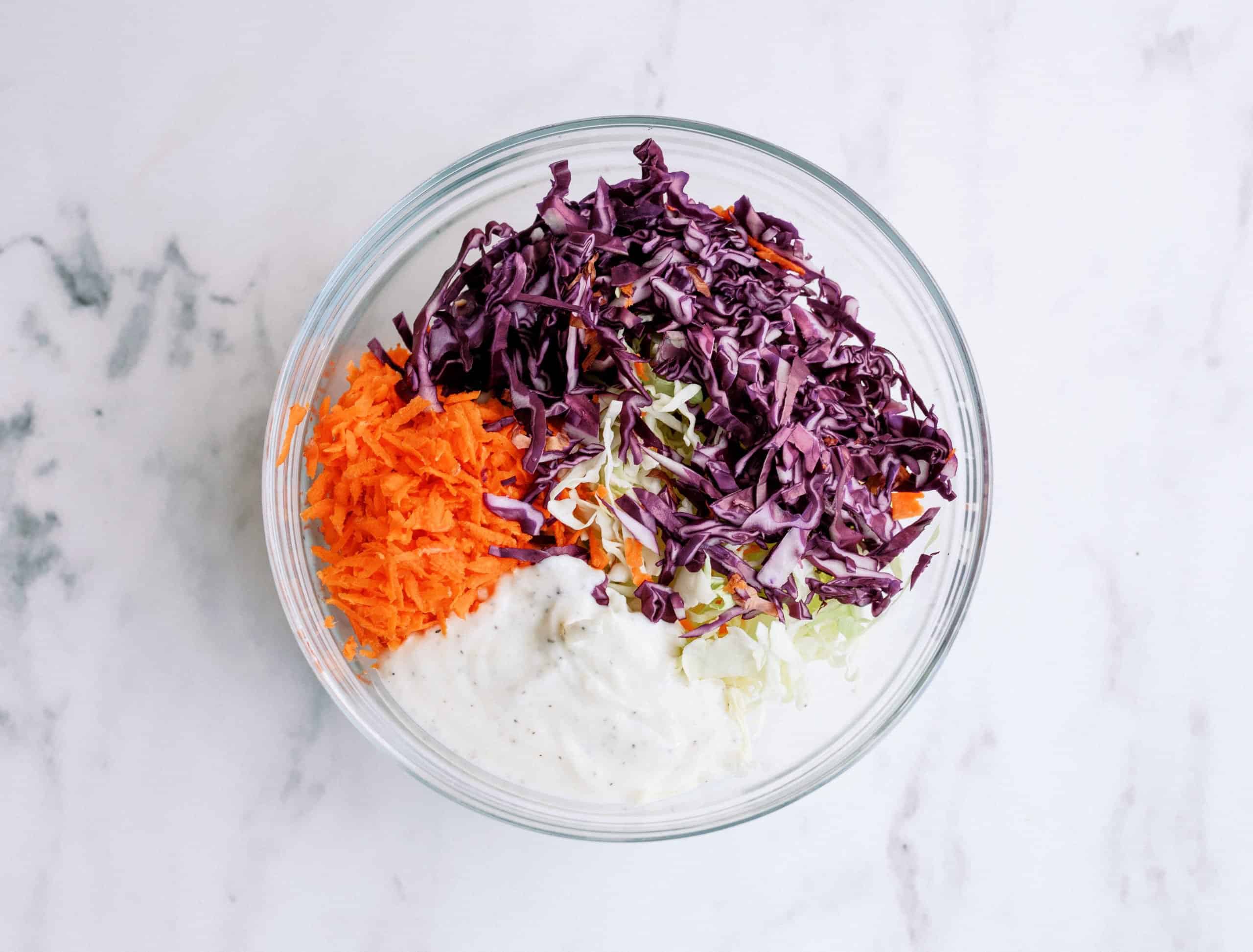 bbq chicken taco coleslaw ingredients in a bowl before mixing