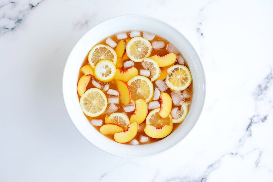 A large punch bowl filled with Sparkling Peach Punch