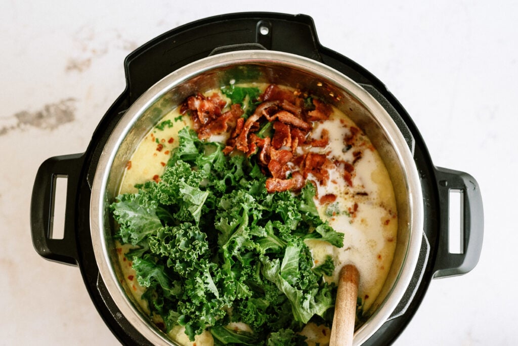 Adding the bacon and chopped kale to the instant pot