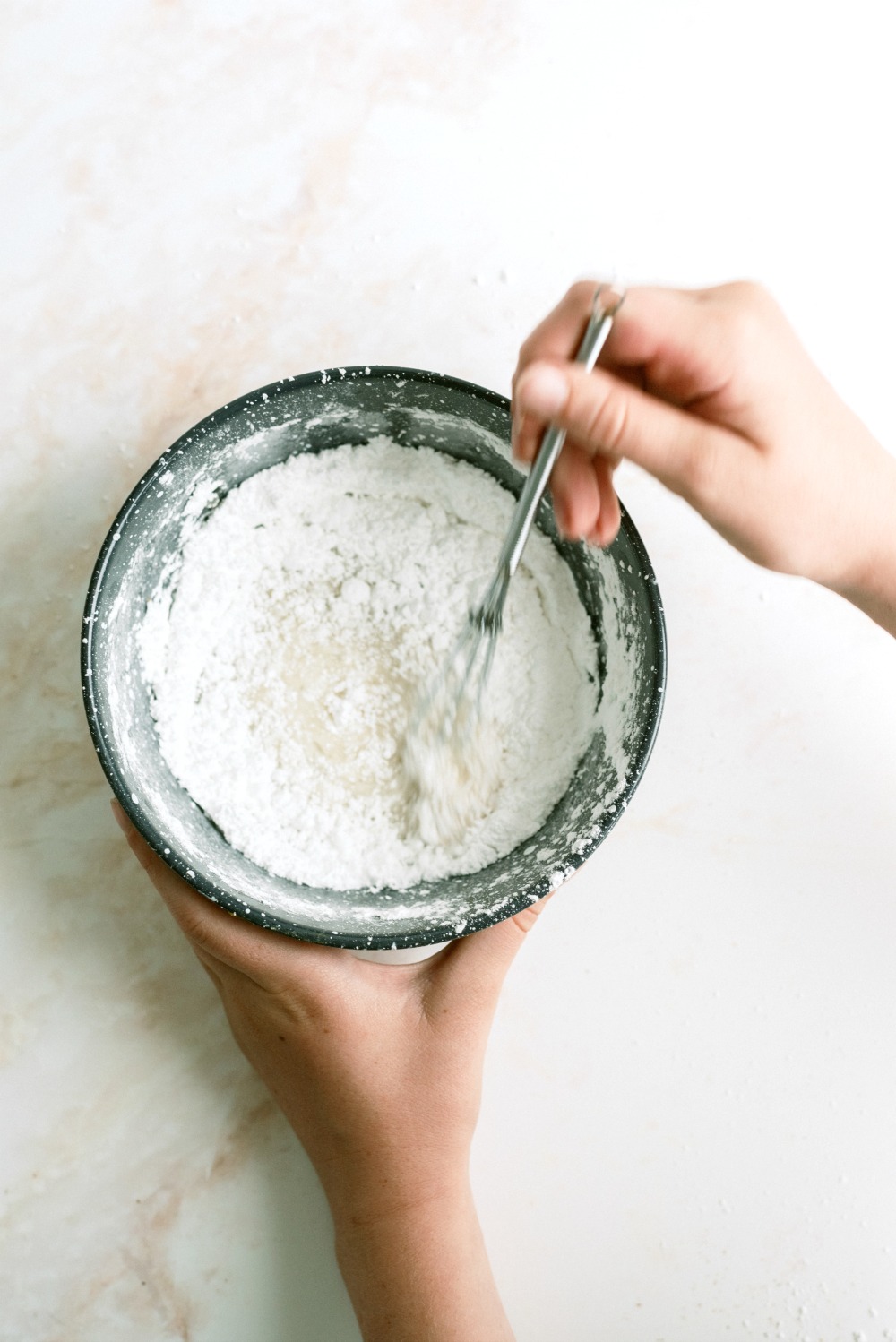 Powdered sugar frosting ingredients mixed in a bowl