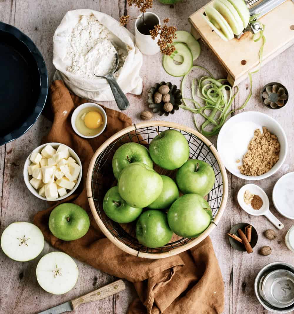 ingredients needed for apple pie laid on a table