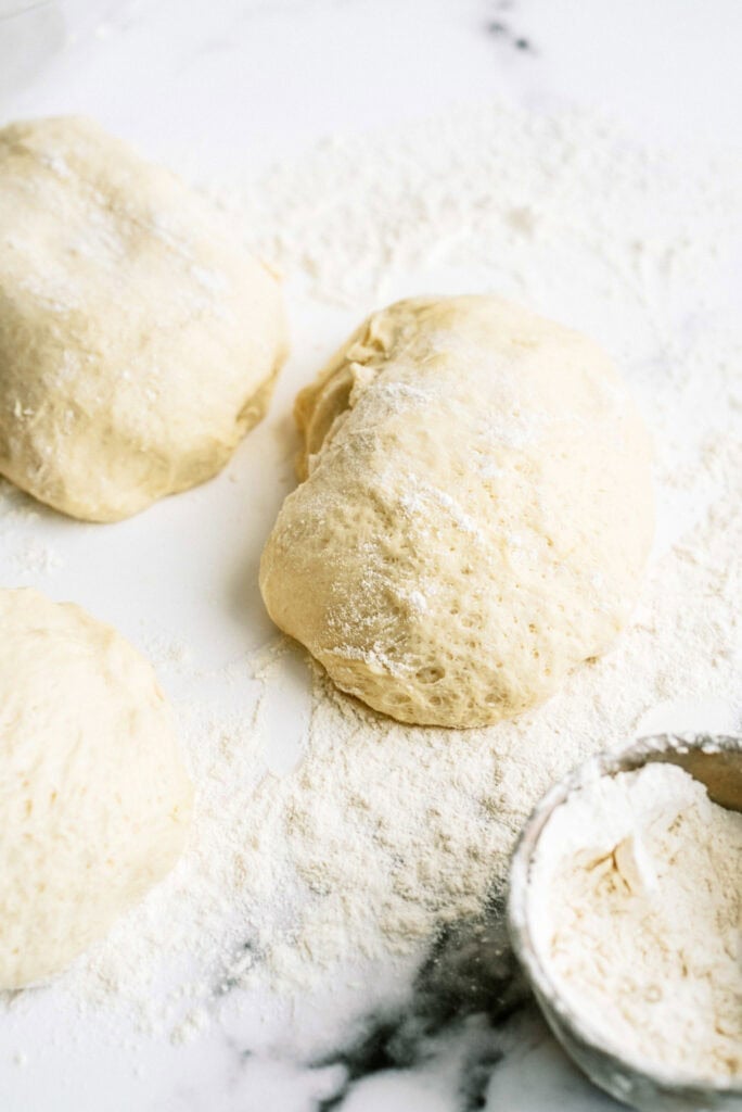 Dough ball lightly floured on a counter top.
