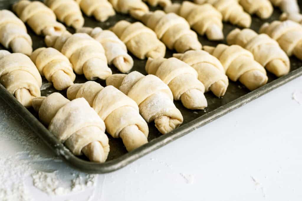 Unbaked Lion House Rolls on a baking sheet.