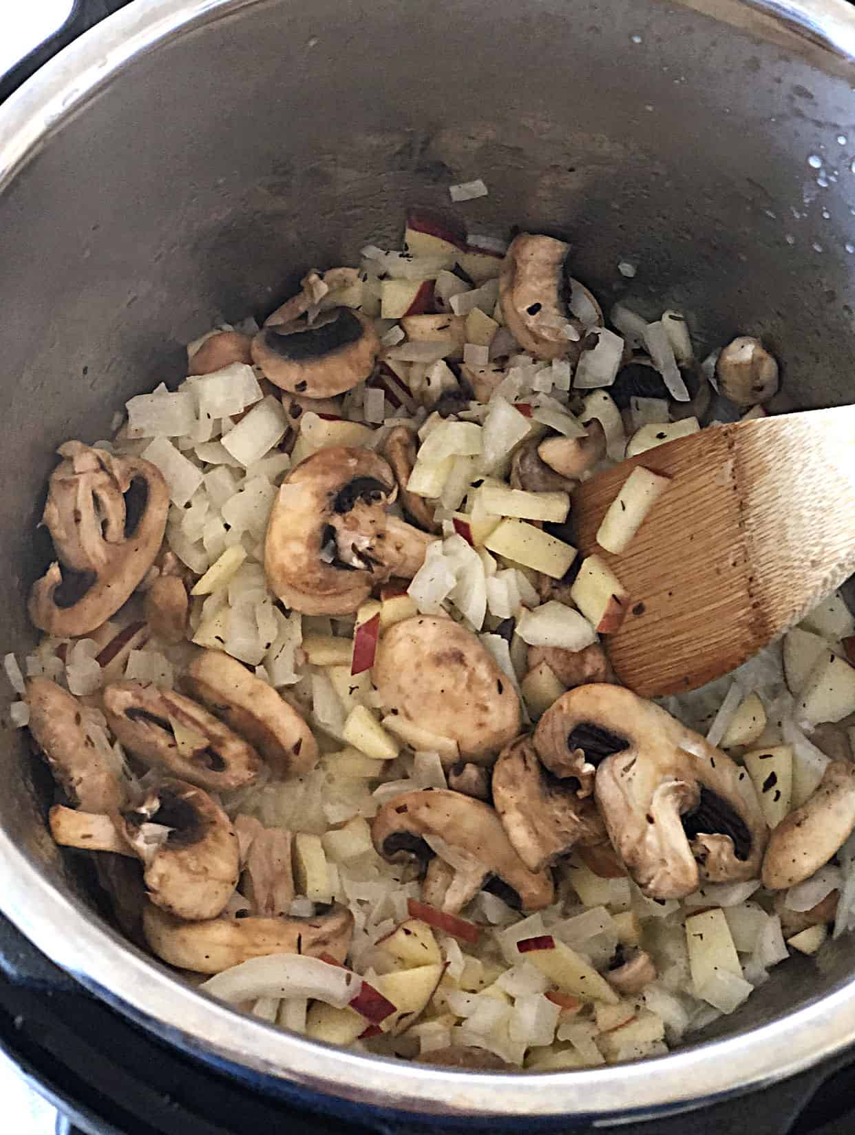 mushrooms, onions, and apples sauteing in instant pot for stuffing