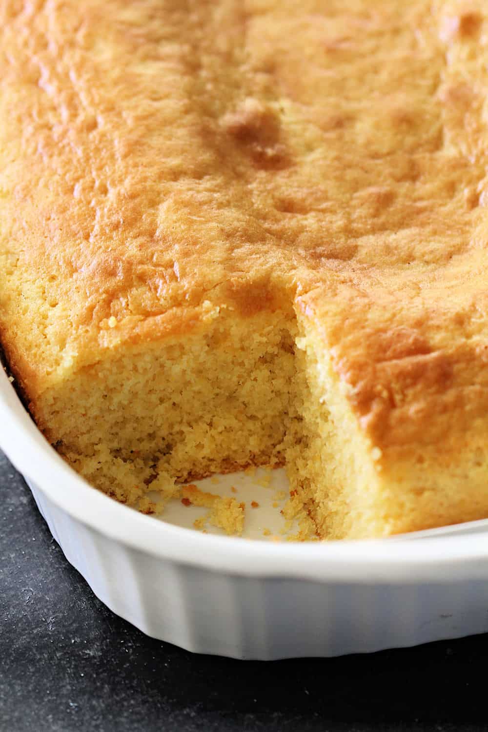 Disneyland’s Sweet Cornbread in a dish with one square of Corn Bread cut out.