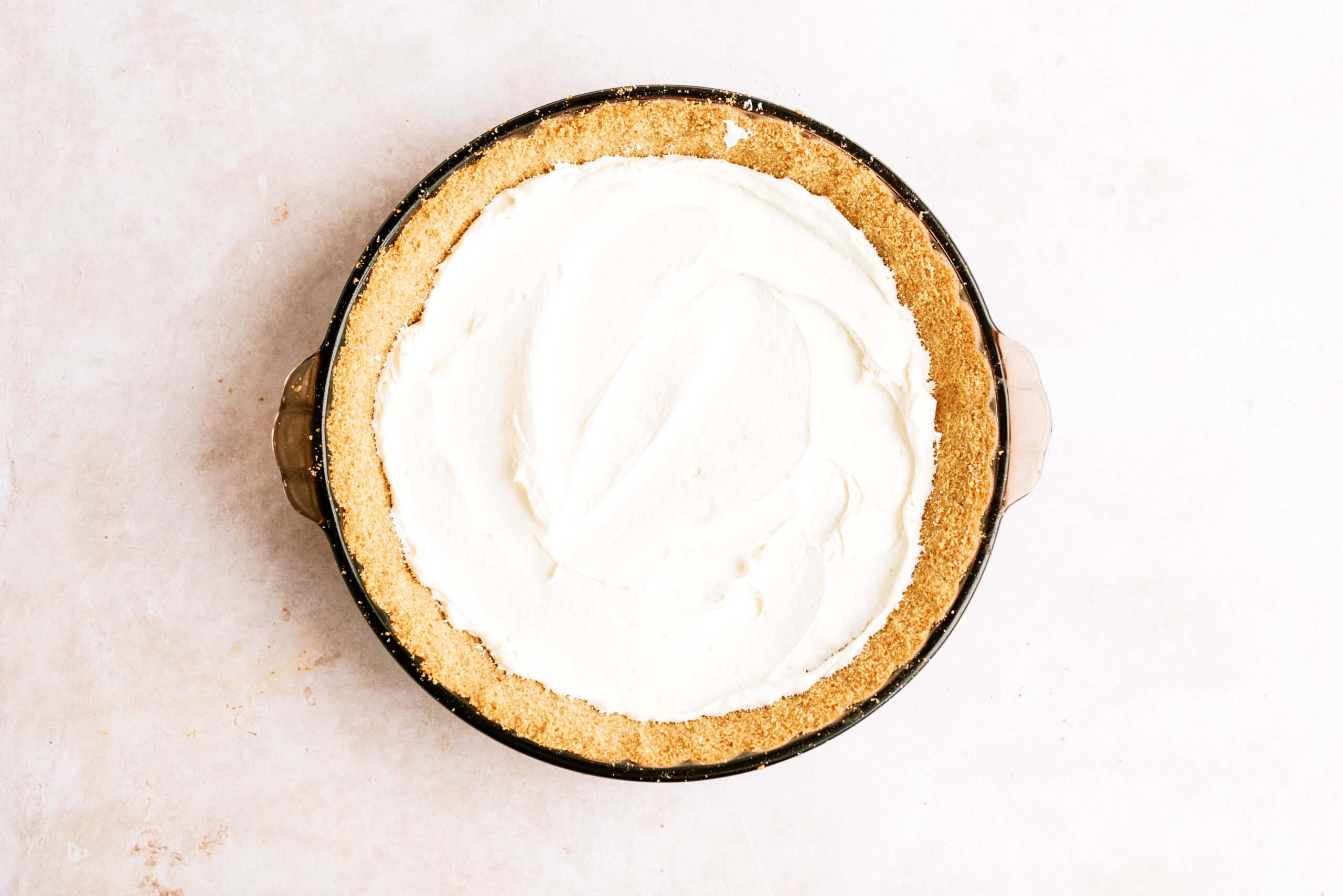 Pie filling and cool whip mixture spread into cool crust
