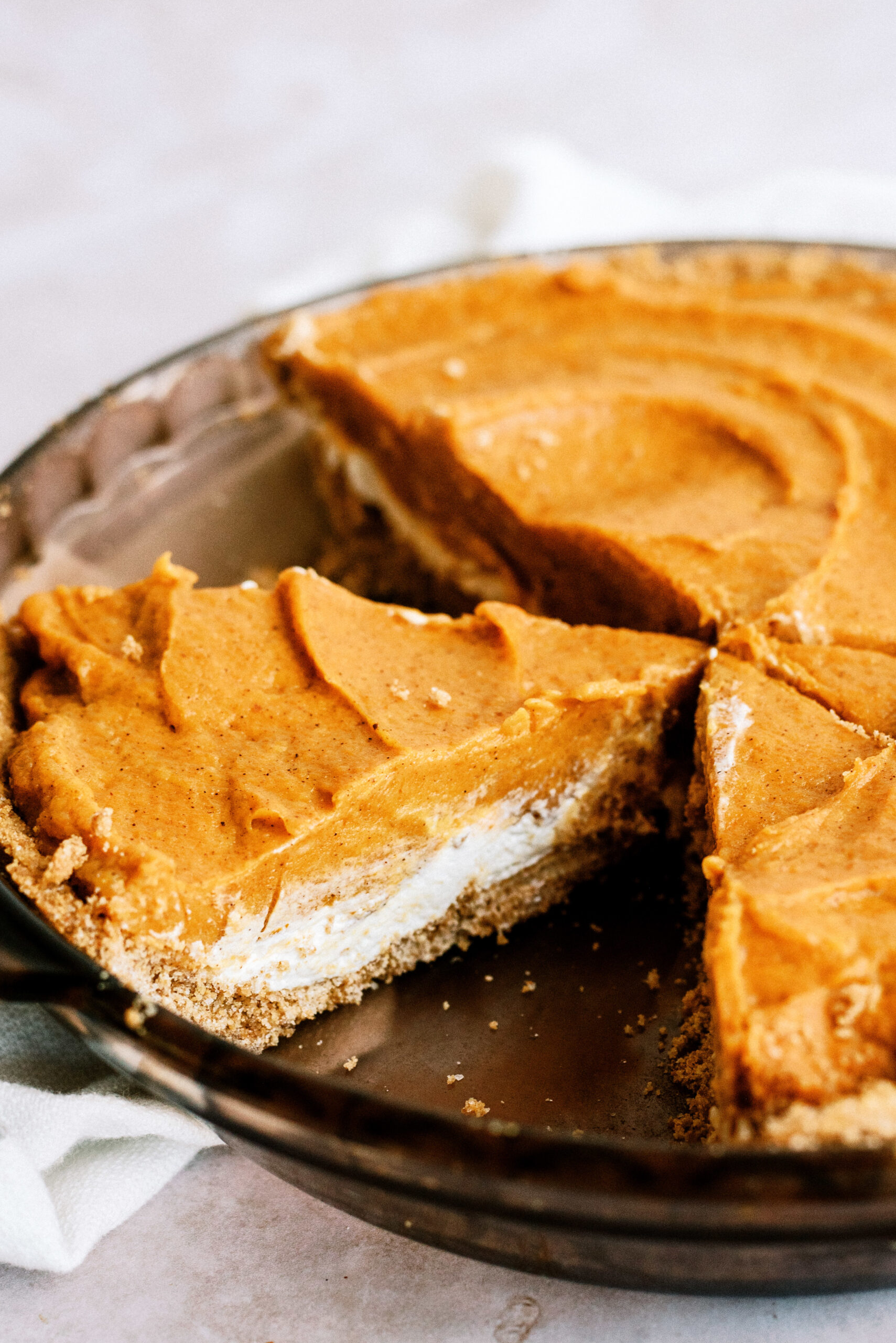 Easy Double Layer Pumpkin Pie in pie plate with a slice missing