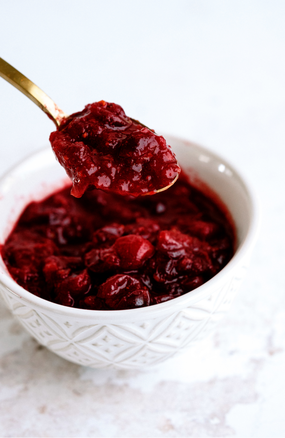 cranberry sauce being dished out with a spoon