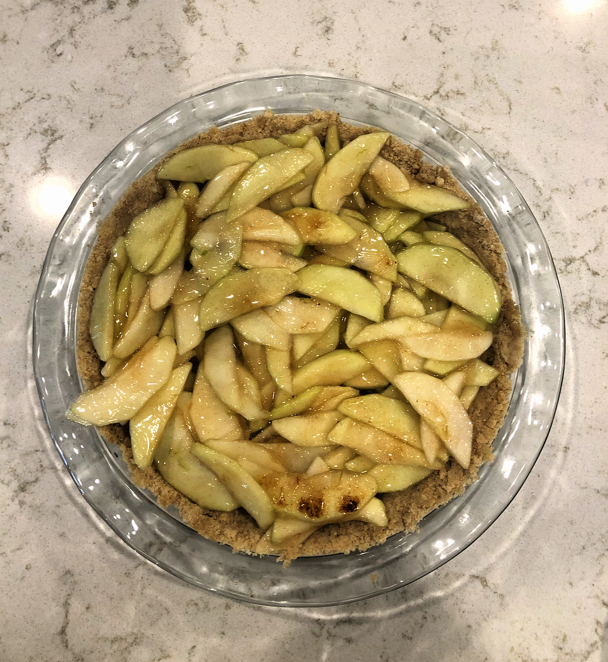 sliced apples in pie crust pressed into pan