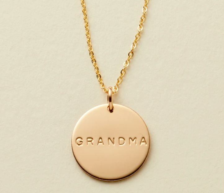 Gold necklace that says "Grandma"