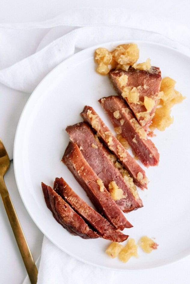 Slow Cooker Pineapple Glazed Ham sliced on a plate