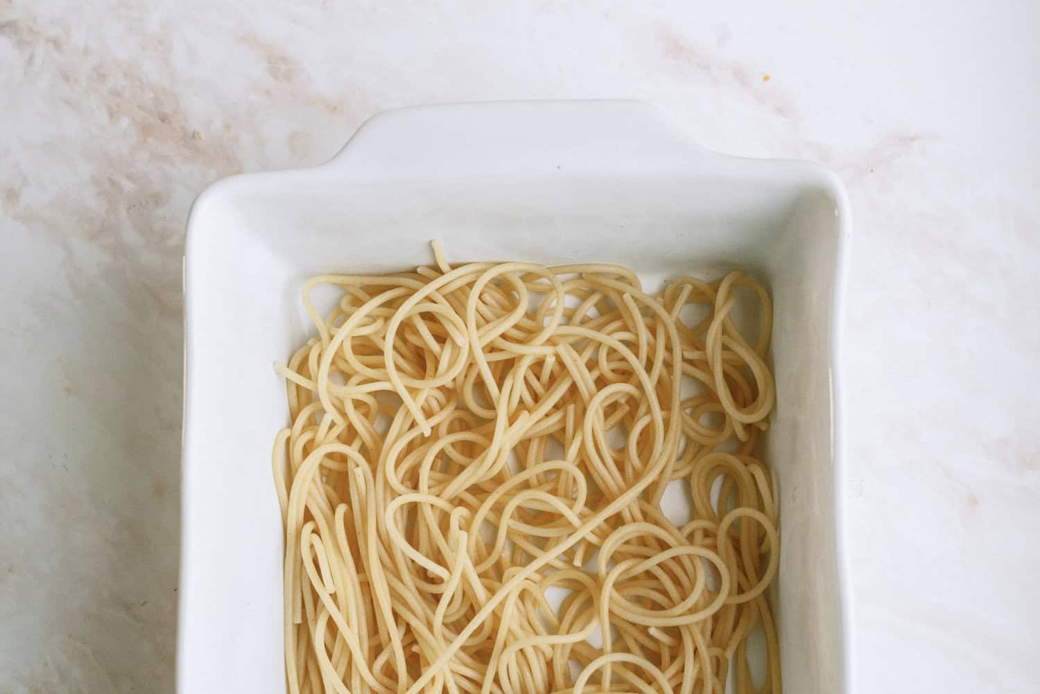 spaghetti noodles in bottom of pan