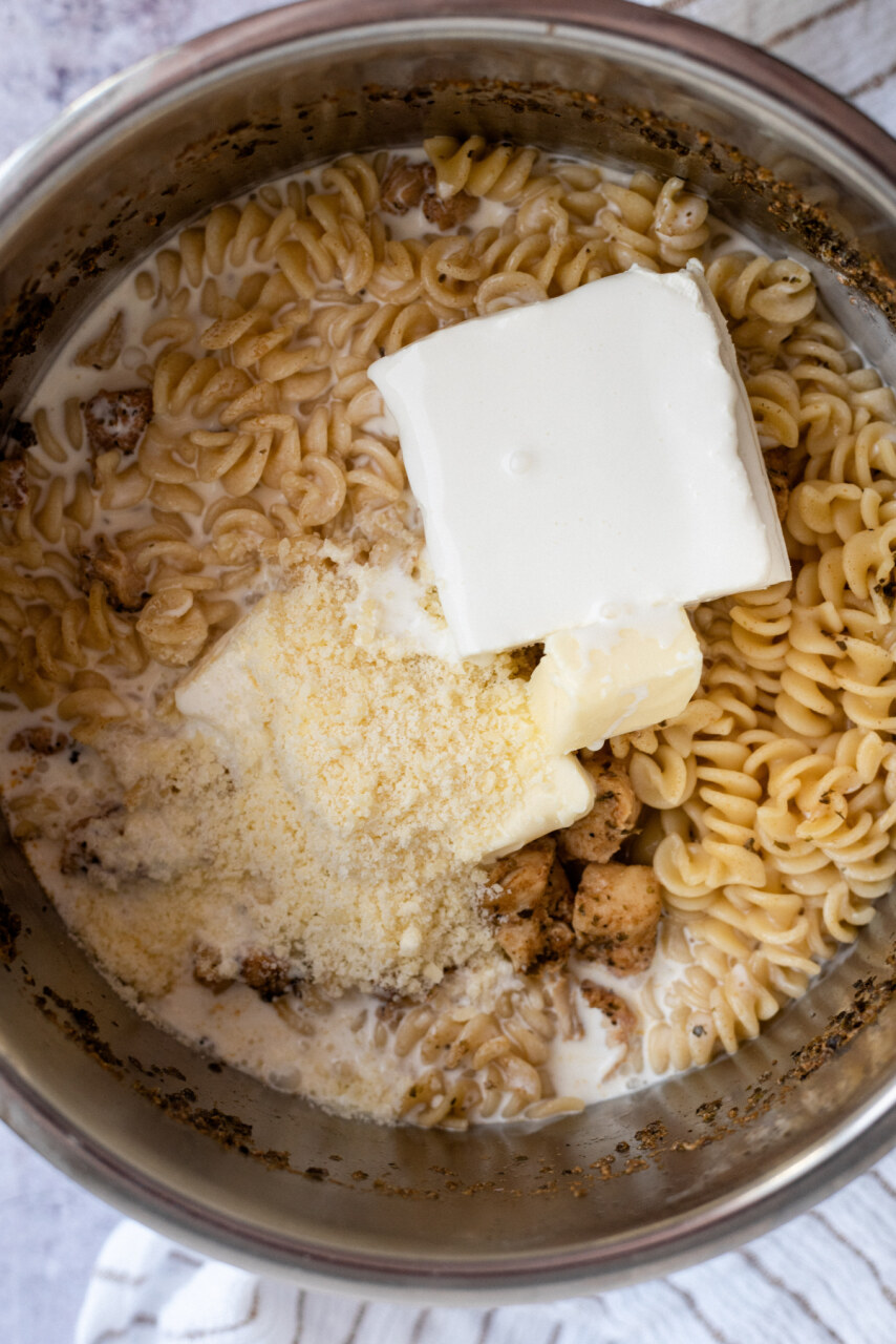 Butter, cream cheese, parmesan cheese, and heavy cream added to the cooked noodles