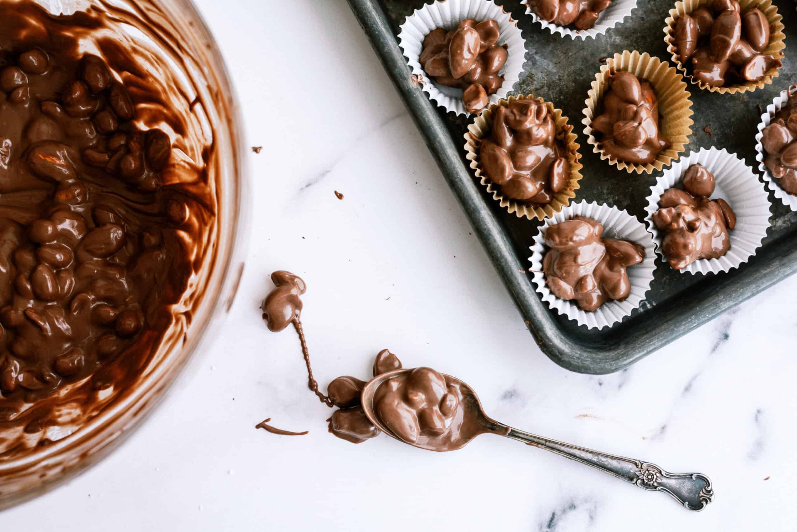 spoon full of nuts and melted chocolate to make peanut clusters