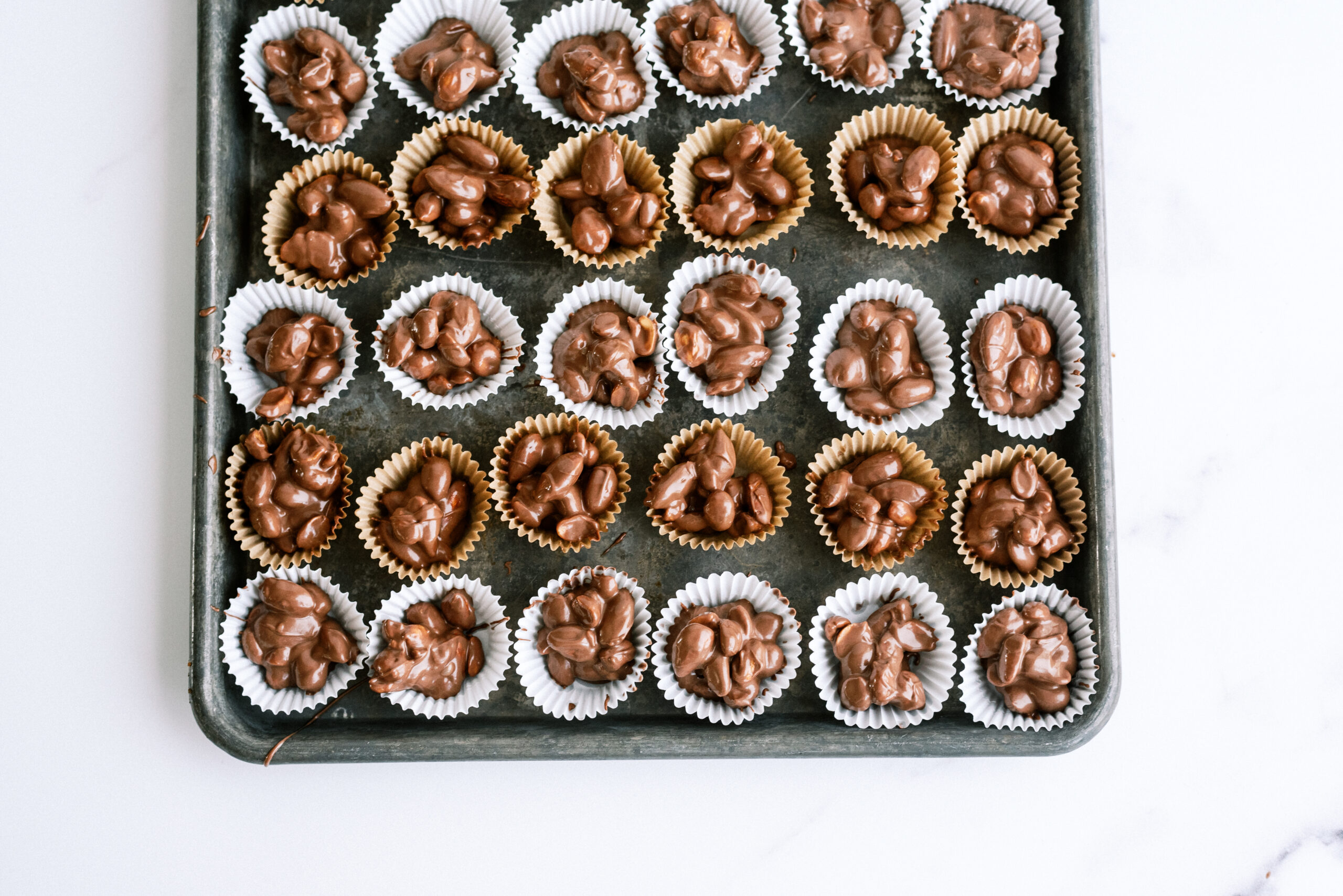 instant pot nut clusters all lined up on a baking sheet