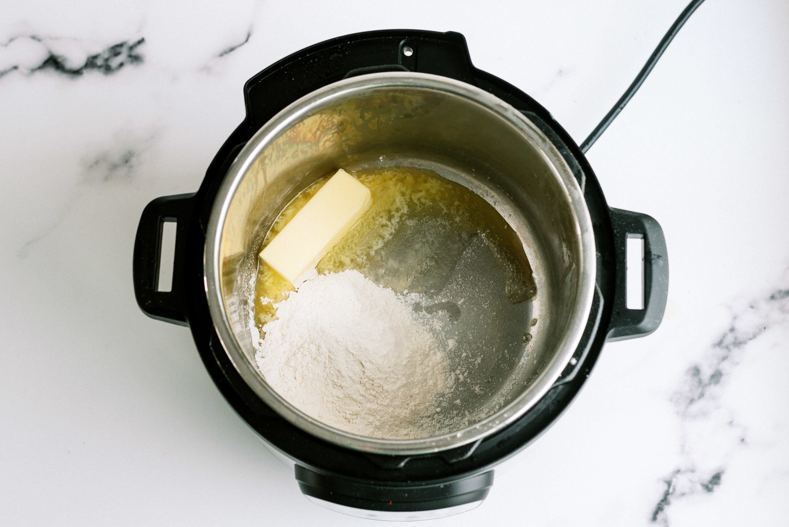 Butter and flour for the Instant Pot Panera Copycat white Cheesy Shells