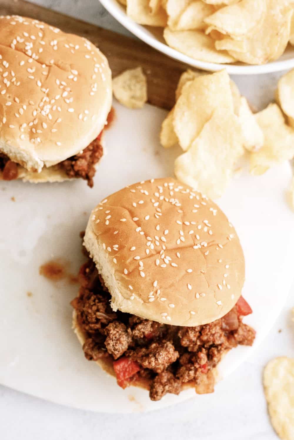 instant pot sloppy joes on buns with potato chips around them