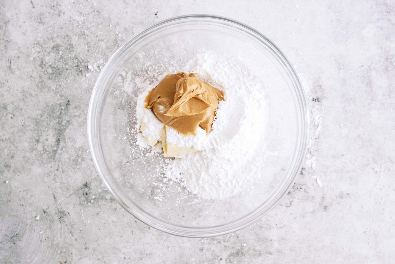 powdered sugar, peanut butter, and butter together in a bowl